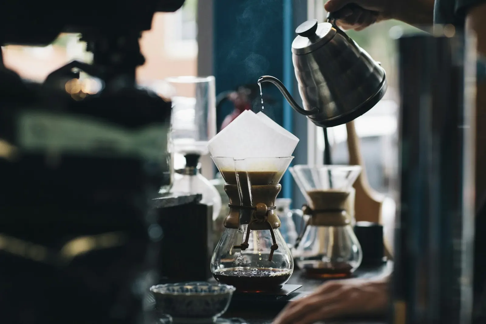 Barista pouring a latte at Ember & Oat