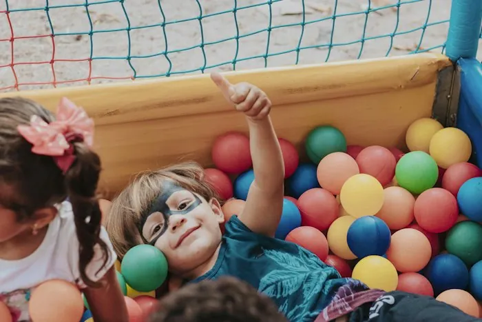 Child smiling in a ball pit