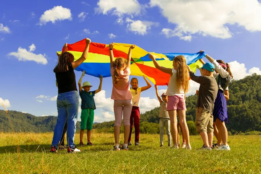 Children playing with a colourful parachute