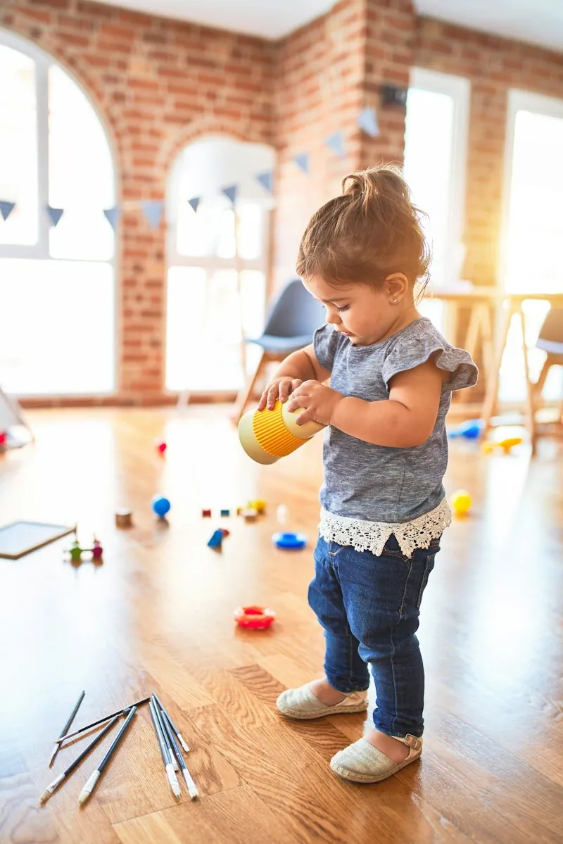 Toddler holding a yellow cup