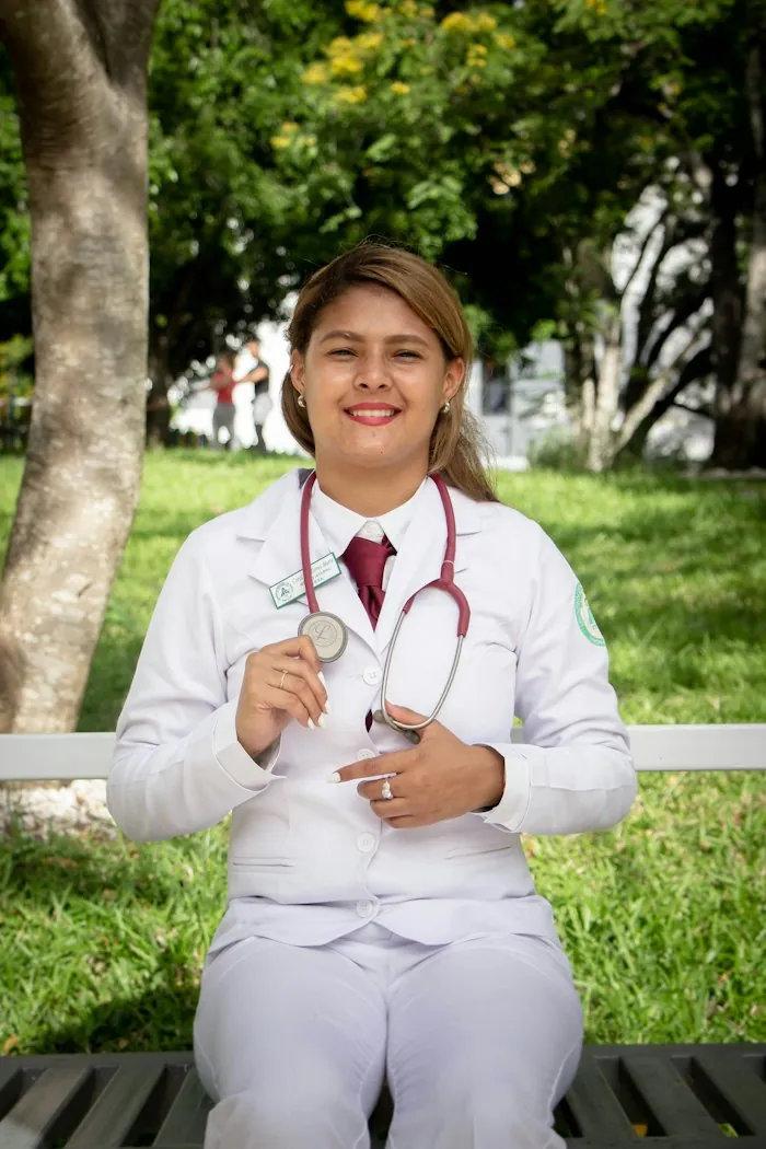 Dr Sofia Marques sitting outdoors with a stethoscope, smiling